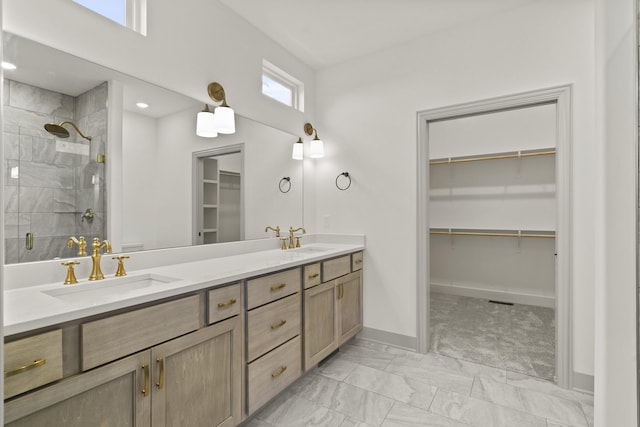 1704 Stillpoint Ct, Columbia, MO 65203 - bathroom with a walk in closet, double vanity, a shower stall, and marble look tile flooring
