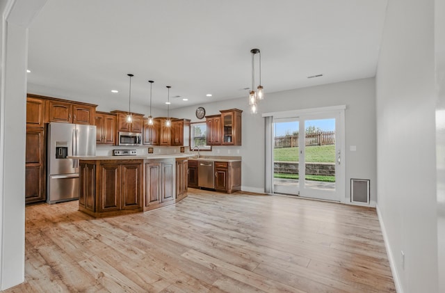 1600 Andretti Cir, Columbia, MO 65201 - kitchen featuring appliances with stainless steel finishes, light countertops, recessed lighting, light wood-type flooring, and glass insert cabinets
