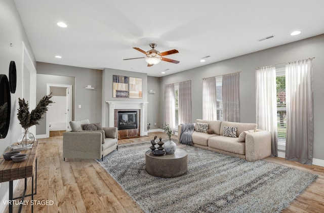 1600 Andretti Cir, Columbia, MO 65201 - living area featuring wood finished floors, a ceiling fan, recessed lighting, and a glass covered fireplace