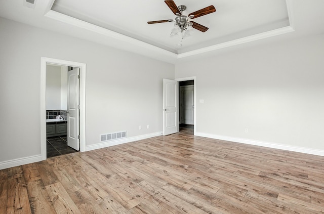 1600 Andretti Cir, Columbia, MO 65201 - unfurnished room with a raised ceiling, wood finished floors, and ceiling fan