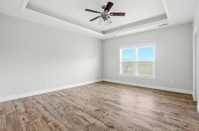 1600 Andretti Cir, Columbia, MO 65201 - spare room with a raised ceiling, wood finished floors, and ceiling fan