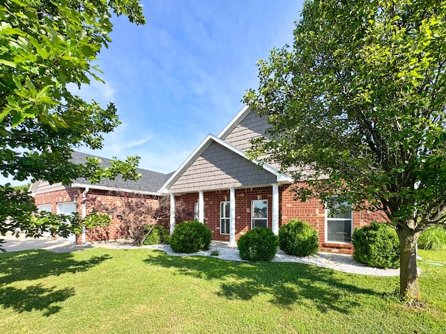 1600 Andretti Cir, Columbia, MO 65201 - view of front facade with brick siding, a front yard, and a garage
