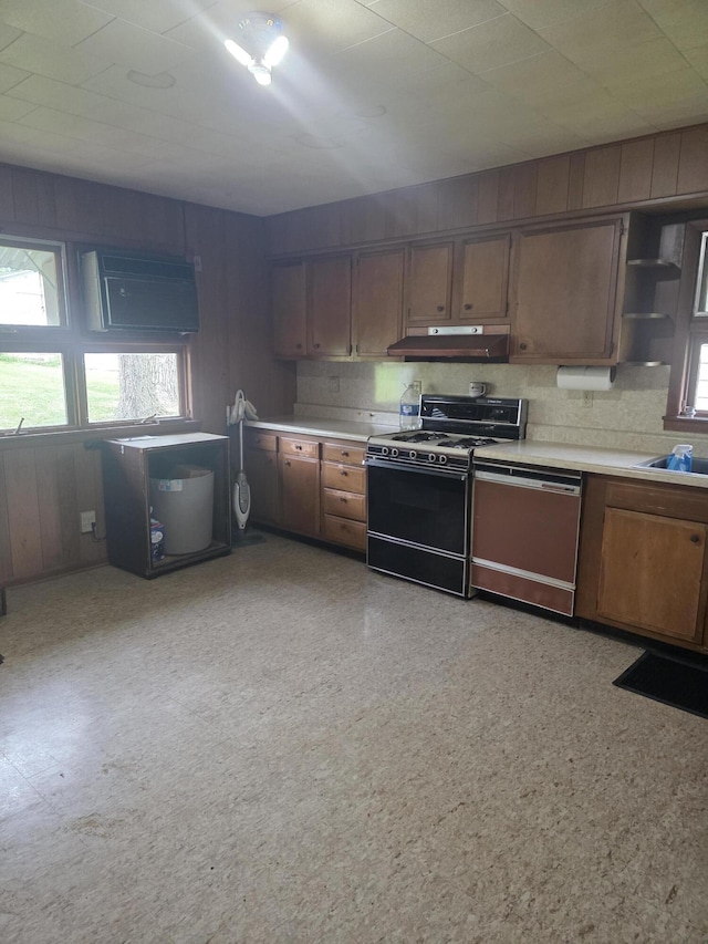 523 W Locust St, Paris, MO 65275 - kitchen featuring range, dishwasher, under cabinet range hood, light countertops, and plenty of natural light