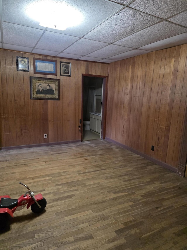 523 W Locust St, Paris, MO 65275 - spare room featuring a drop ceiling, wood finished floors, and wood walls
