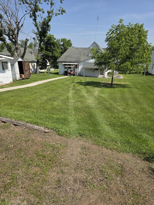 523 W Locust St, Paris, MO 65275 - view of grassy yard with a carport and an outbuilding