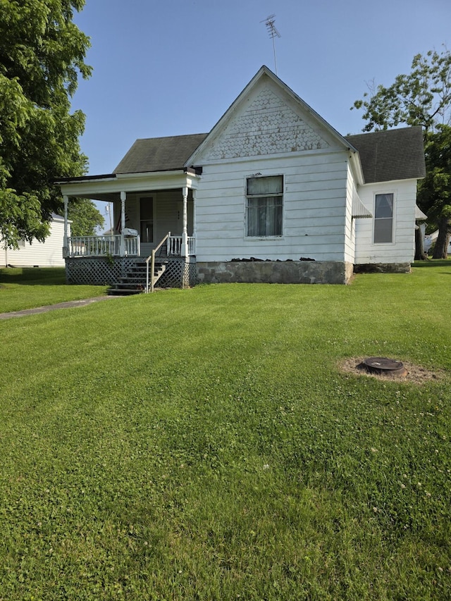 523 W Locust St, Paris, MO 65275 - view of front of home with covered porch, a front yard, and roof with shingles