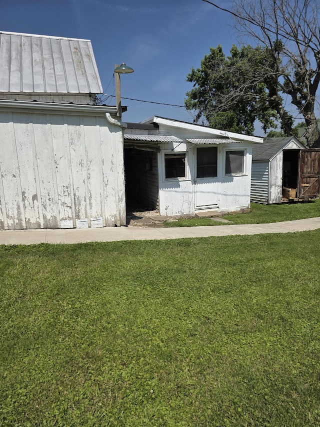 523 W Locust St, Paris, MO 65275 - view of front of property with a front lawn, a shed, and a metal roof