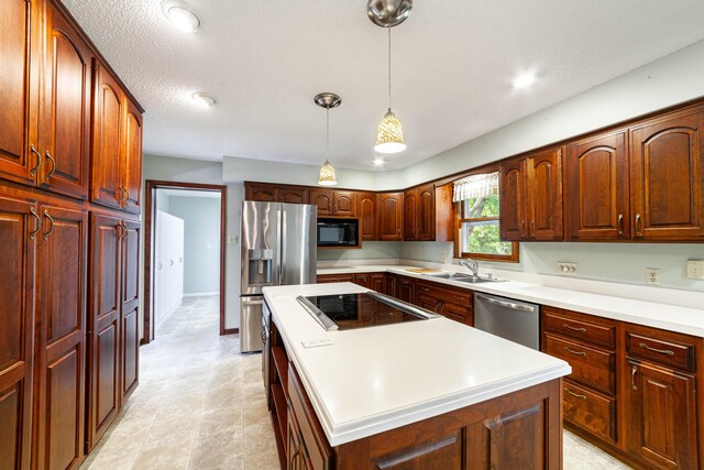 4705 Roemer Rd, Columbia, MO 65202 - kitchen with black appliances, a center island, pendant lighting, and light countertops
