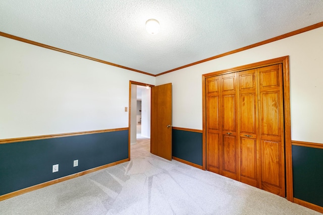 4705 Roemer Rd, Columbia, MO 65202 - unfurnished bedroom featuring carpet floors, a textured ceiling, crown molding, and a closet