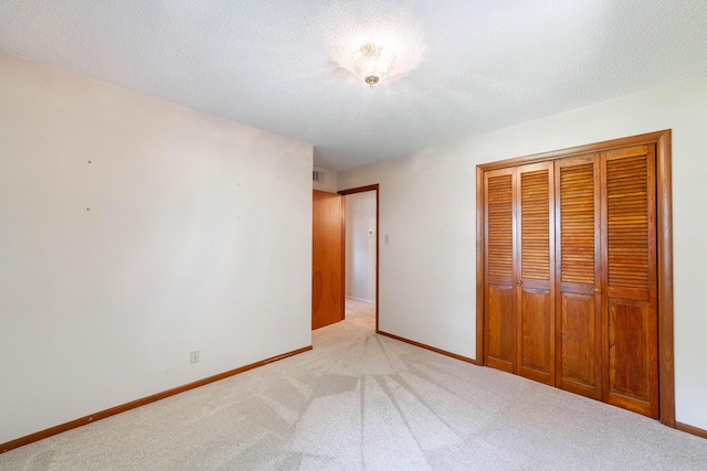 4705 Roemer Rd, Columbia, MO 65202 - unfurnished bedroom with light colored carpet, a closet, and a textured ceiling