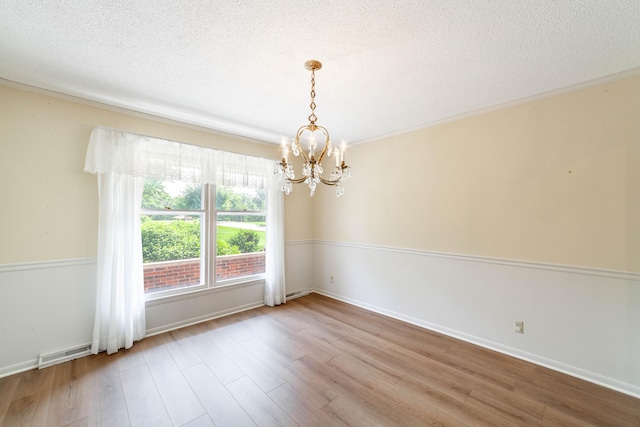 4705 Roemer Rd, Columbia, MO 65202 - spare room with a chandelier, wood finished floors, ornamental molding, and a textured ceiling