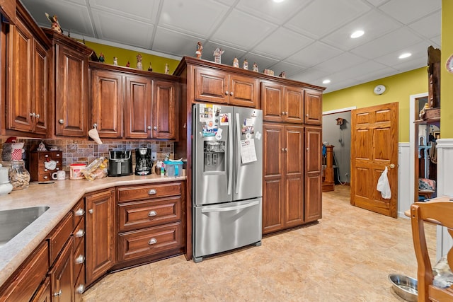 801 Court St, Fulton, MO 65251 - kitchen with stainless steel fridge, recessed lighting, light countertops, backsplash, and brown cabinetry