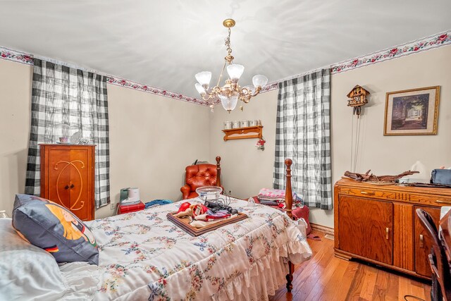 801 Court St, Fulton, MO 65251 - bedroom with a chandelier and hardwood / wood-style floors