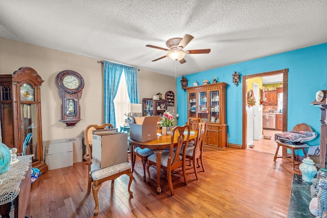 801 Court St, Fulton, MO 65251 - dining room featuring a ceiling fan, light wood-style floors, and a textured ceiling