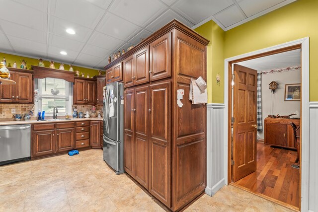 801 Court St, Fulton, MO 65251 - kitchen featuring stainless steel appliances, light countertops, decorative backsplash, wainscoting, and recessed lighting