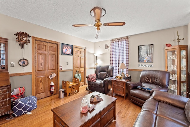 801 Court St, Fulton, MO 65251 - living room featuring a ceiling fan, light wood-style floors, and a textured ceiling