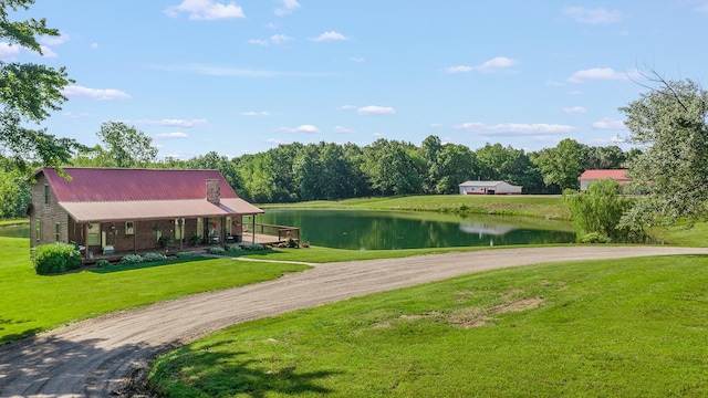 4604 County Road 115, Fulton, MO 65251 - view of front facade featuring a water view, driveway, a porch, and a front lawn