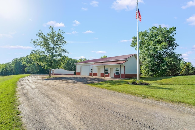4604 County Road 115, Fulton, MO 65251 - ranch-style home with driveway, a front lawn, a detached garage, and an outdoor structure