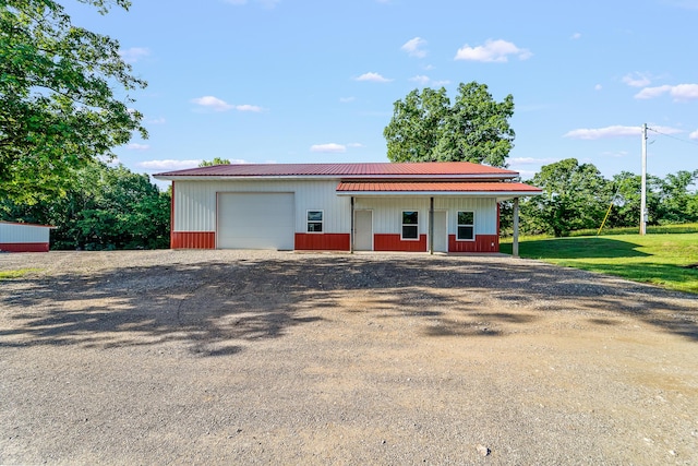 4604 County Road 115, Fulton, MO 65251 - view of front of house featuring an outbuilding, a metal roof, a detached garage, and driveway