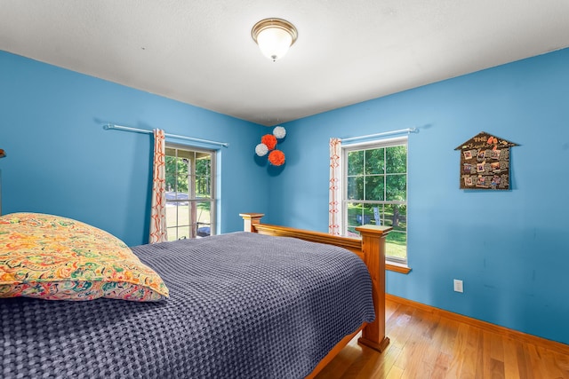4604 County Road 115, Fulton, MO 65251 - bedroom featuring multiple windows and wood finished floors