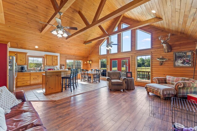 4604 County Road 115, Fulton, MO 65251 - living room with a ceiling fan, a wooden ceiling with exposed beams, high vaulted ceiling, light wood finished floors, and wooden walls