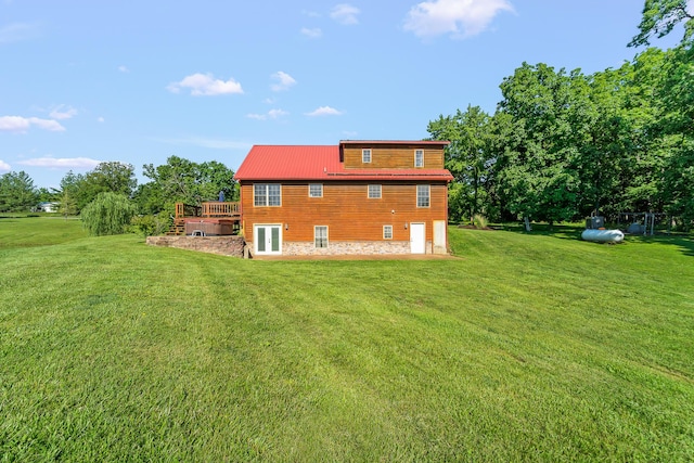 4604 County Road 115, Fulton, MO 65251 - back of property with a yard, a wooden deck, stone siding, and a metal roof