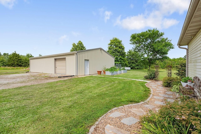 9050 Hartley Rd, Hallsville, MO 65255 - view of grassy yard with an outdoor structure, a garage, and a pole building