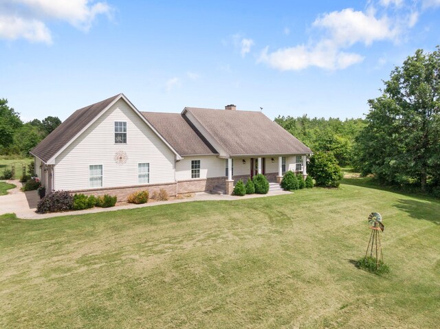 9050 Hartley Rd, Hallsville, MO 65255 - view of front of home featuring a porch, brick siding, a chimney, and a front lawn
