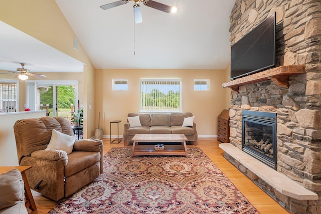 9050 Hartley Rd, Hallsville, MO 65255 - living room with a ceiling fan, high vaulted ceiling, a fireplace, and light wood finished floors