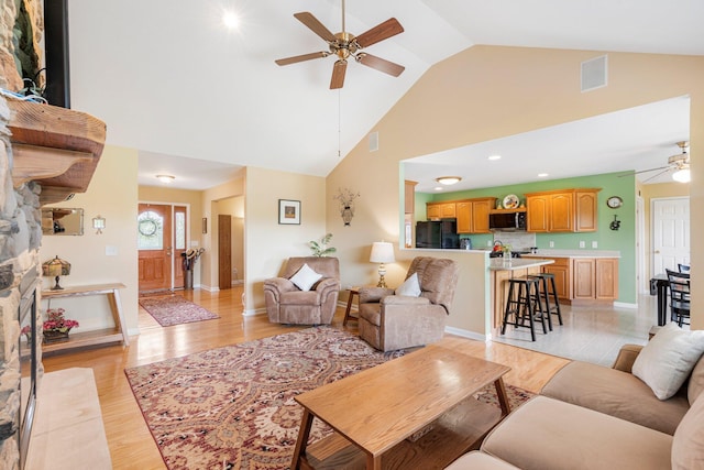 9050 Hartley Rd, Hallsville, MO 65255 - living area featuring a ceiling fan, high vaulted ceiling, and light wood-type flooring