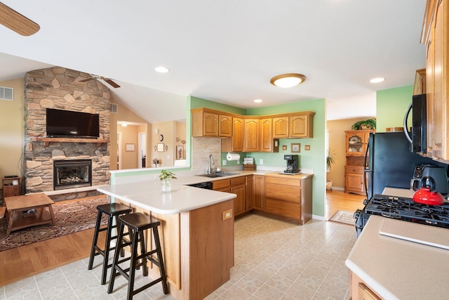 9050 Hartley Rd, Hallsville, MO 65255 - kitchen featuring a ceiling fan, a peninsula, black microwave, light countertops, and lofted ceiling