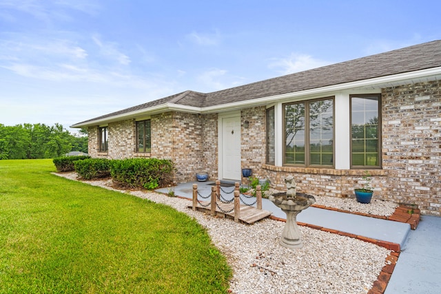 7275 N Route E, Columbia, MO 65202 - property entrance featuring a lawn, brick siding, and a shingled roof