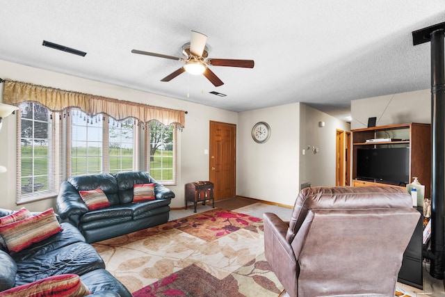 7275 N Route E, Columbia, MO 65202 - living area featuring ceiling fan, a textured ceiling, and light colored carpet