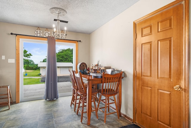 7275 N Route E, Columbia, MO 65202 - dining space featuring a chandelier and a textured ceiling