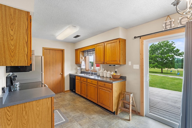 7275 N Route E, Columbia, MO 65202 - kitchen with black dishwasher, stove, brown cabinetry, a textured ceiling, and dark countertops