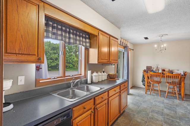 7275 N Route E, Columbia, MO 65202 - kitchen featuring dark countertops, dishwasher, brown cabinetry, a chandelier, and a textured ceiling