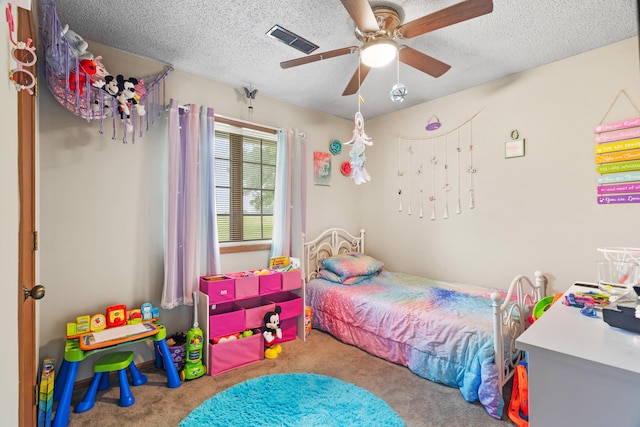 7275 N Route E, Columbia, MO 65202 - carpeted bedroom with a textured ceiling and ceiling fan