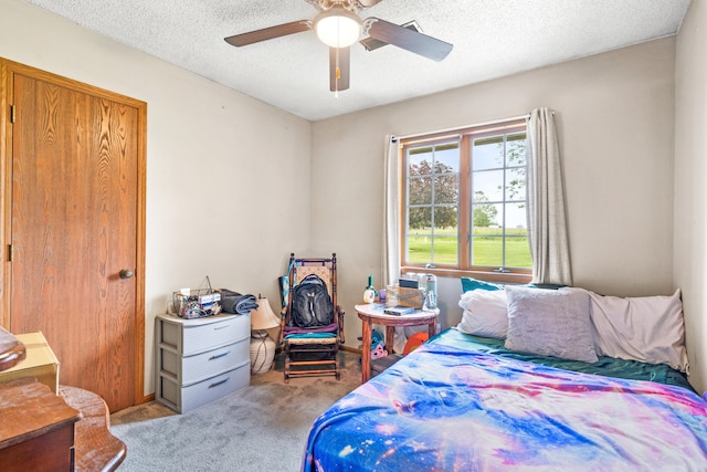 7275 N Route E, Columbia, MO 65202 - bedroom with carpet flooring, a textured ceiling, and ceiling fan
