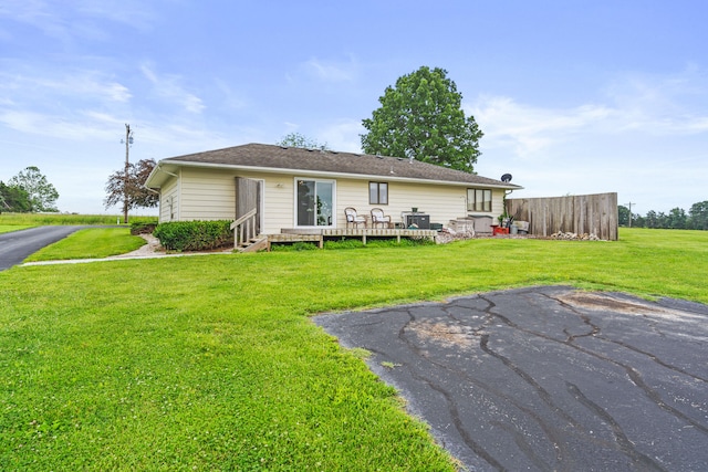 7275 N Route E, Columbia, MO 65202 - back of property featuring a lawn and a wooden deck