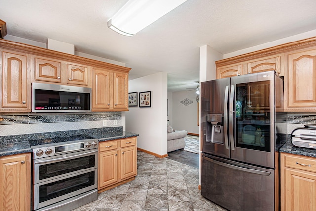 11100 E J B Ln, Hallsville, MO 65255 - kitchen with appliances with stainless steel finishes, tasteful backsplash, ceiling fan, dark stone countertops, and light stone finish flooring