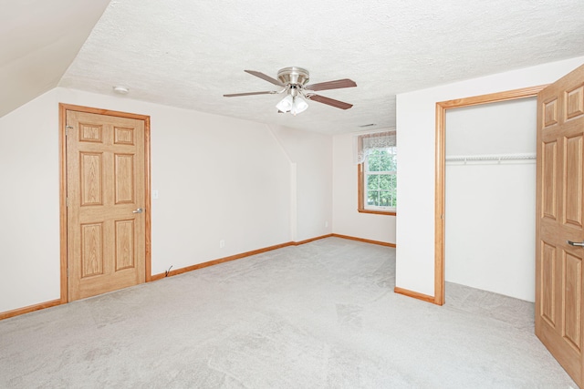 11100 E J B Ln, Hallsville, MO 65255 - unfurnished bedroom featuring carpet floors, a ceiling fan, a closet, a textured ceiling, and lofted ceiling