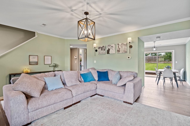 5010 Aspen Ridge Dr, Columbia, MO 65202 - living area featuring wood finished floors, a chandelier, and ornamental molding