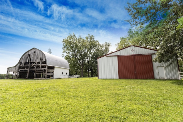 1001 Randolph St, Glasgow, MO 65254 - view of grassy yard with an outdoor structure, a garage, and a barn