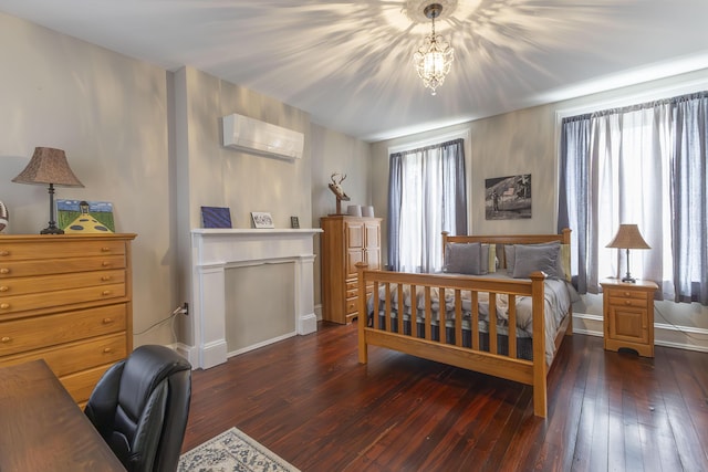 1001 Randolph St, Glasgow, MO 65254 - bedroom featuring wood-type flooring, a wall mounted air conditioner, and a desk