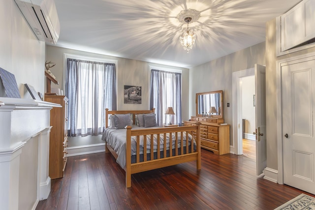 1001 Randolph St, Glasgow, MO 65254 - bedroom featuring a wall mounted AC, multiple windows, and dark wood finished floors