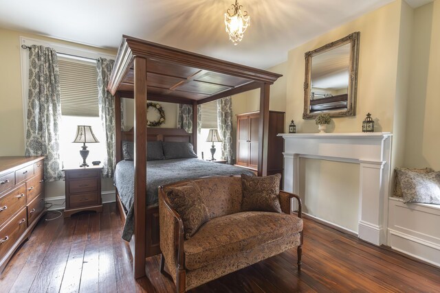 1001 Randolph St, Glasgow, MO 65254 - bedroom with dark wood finished floors and a chandelier