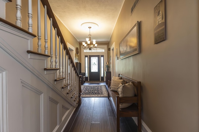 1001 Randolph St, Glasgow, MO 65254 - foyer entrance featuring a chandelier, stairway, and dark wood-type flooring