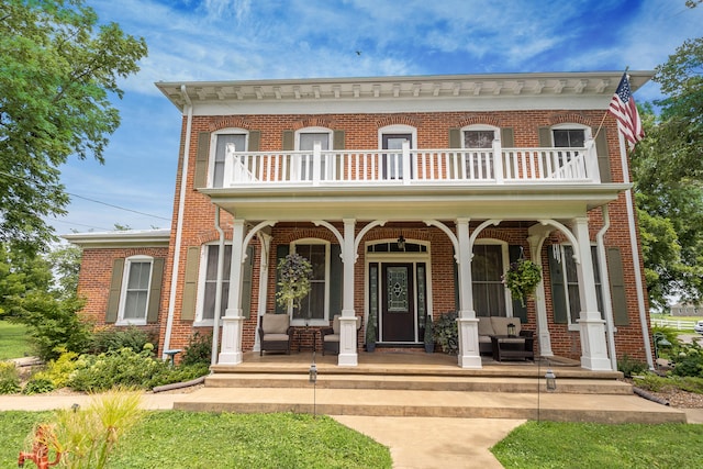 1001 Randolph St, Glasgow, MO 65254 - view of front facade featuring a balcony, a porch, and brick siding