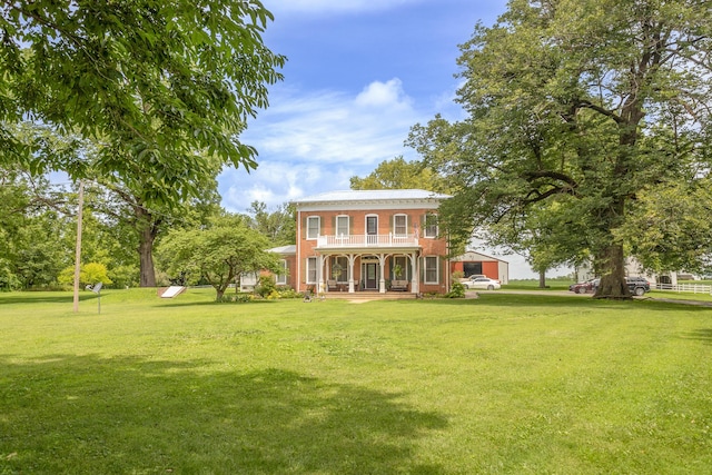 1001 Randolph St, Glasgow, MO 65254 - back of house featuring covered porch, a yard, and brick siding