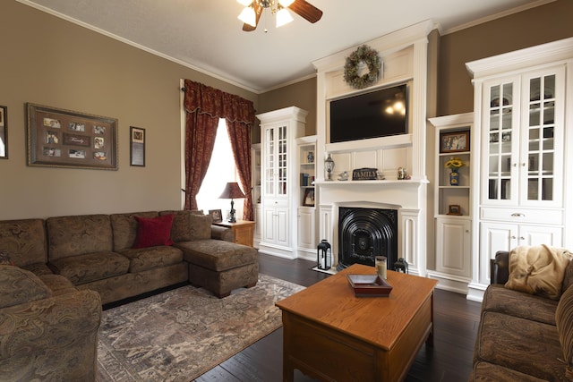 1001 Randolph St, Glasgow, MO 65254 - living room featuring a ceiling fan, dark wood-style floors, ornamental molding, and a fireplace with flush hearth